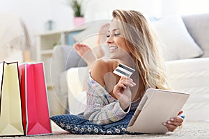 Happy woman shopping online with credit card