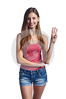 Happy woman in shorts showing three fingers