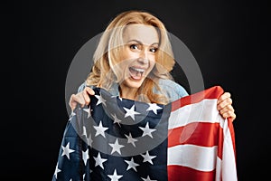 Happy woman showing American flag