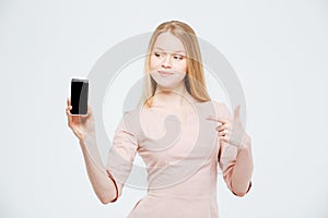 Happy woman showing blank smartphone screen