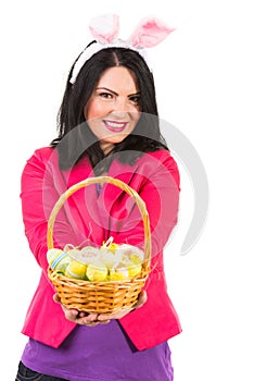 Happy woman showing Easter basket with eggs