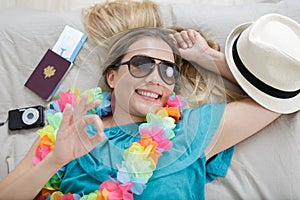 Happy woman showing ok sign before going on holidays