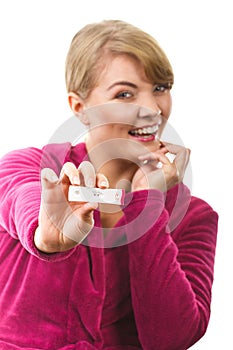 Happy woman showing pregnancy test with positive result