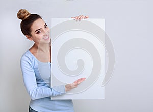 Happy woman showing signboard with blank space for advertisiment photo