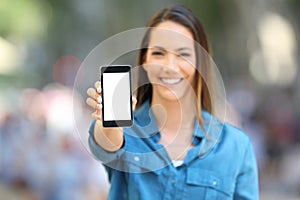 Happy woman showing smart phone mock up