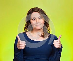 Happy woman showing thumbs up gesture