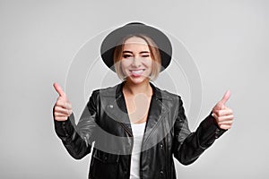 Happy woman showing thumbs up over background