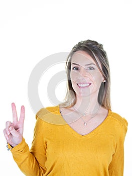 Happy woman showing v sign at studio over isolated white background smiling finger victory signage palm hand