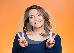 Happy woman showing victory sign