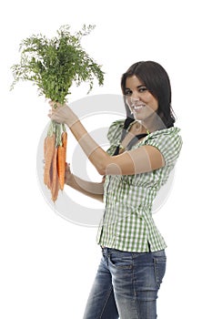 Happy woman shows on a bunch of carrots