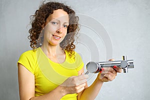 Happy woman shows faucet water in repairable