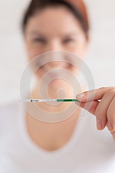 Happy woman shows a negative pregnancy test. The concept of female fertility. Human chorionic gonadotropin. One strip