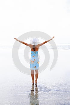 Happy woman silhouette with hands up. Westport, New Zealand.