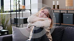 Happy Woman Sitting On Comfortable Sofa At Home Living Room