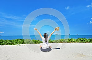 Happy woman sitting enjoy life on beach