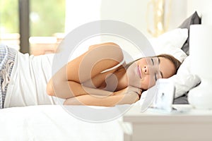 Happy woman sleeping deeply in a comfortable bed