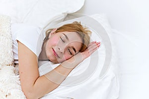 Happy woman sleeps in the morning in her bed. Healthy sleep