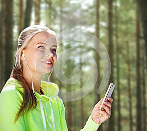 Happy woman with smartphone and earphones