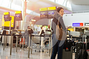 Happy woman with smile hand holding passport and boarding pass.