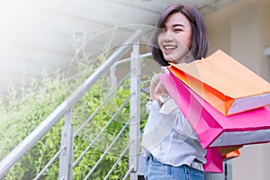 Happy woman smile and holding shpping bags shopping on the day photo