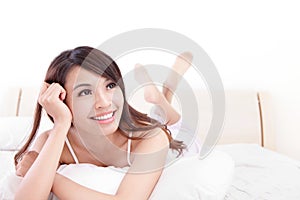 Happy woman smile while lying on the bed