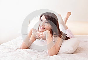 Happy woman smile while lying on the bed