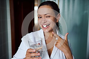 Happy woman smiles at camera, taking pills for antidepressant therapy. Mental health. Treating depression, panic attacks