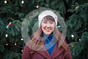 Happy woman smiling and Christmas tree behind