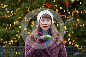 Happy woman smiling and Christmas tree behind