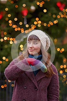 Happy woman smiling and Christmas tree behind