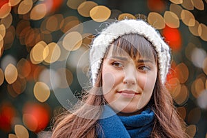 Happy woman smiling and Christmas tree behind