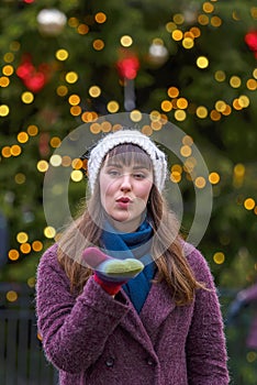 Happy woman smiling and Christmas tree behind