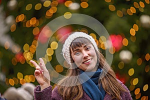 Happy woman smiling and Christmas tree behind