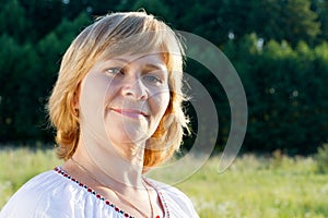 Happy woman smiling in the nature background.