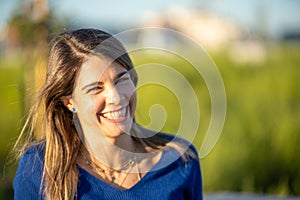 Happy woman smiling outdoors in nature