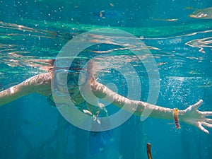 Happy woman snorkeling at clear waters underwater view Maldives island