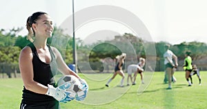Happy woman, soccer and goal keeper with ball for defense in team sport or position on green grass field. Female person