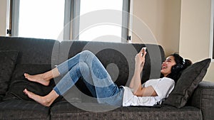 Happy woman on the sofa at home