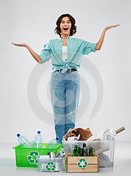 Happy woman sorting paper, metal and plastic waste