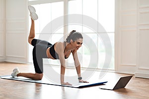 Happy Woman In Sportswear Doing Donkey Kicks Exercise