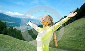 Happy woman in sportswear enjoying sun and freedom