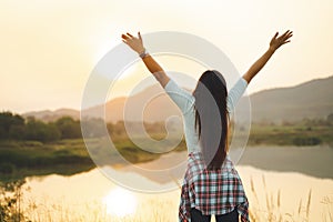 Happy woman spreading arms and watching the mountain. Travel Lifestyle success concept adventure active vacations outdoor freedom