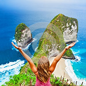 Happy woman stand at high cliff viewpoint, look at sea