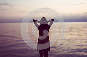 Happy woman standing with hands on head at sea,Enjoying in Nature,Freedom concept