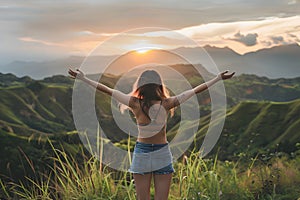 Happy woman standing with her back on sunset in nature