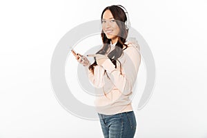 Happy woman standing isolated using mobile phone.