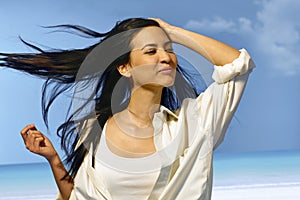 Happy woman standing in summer wind