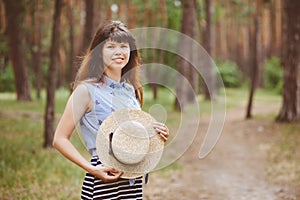 Happy woman with straw boater hat smile in countryside village on nature