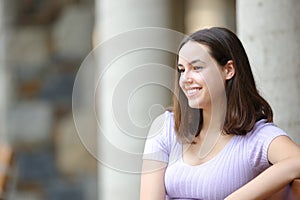 Happy woman in the street looks away
