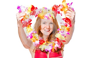 Happy woman stretches floral lei for a holiday